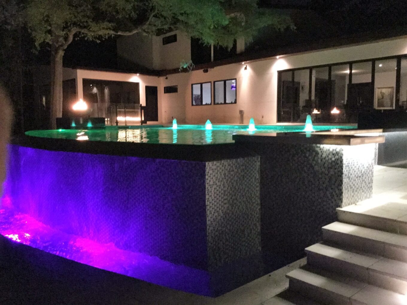 A pool with lights on the side of it