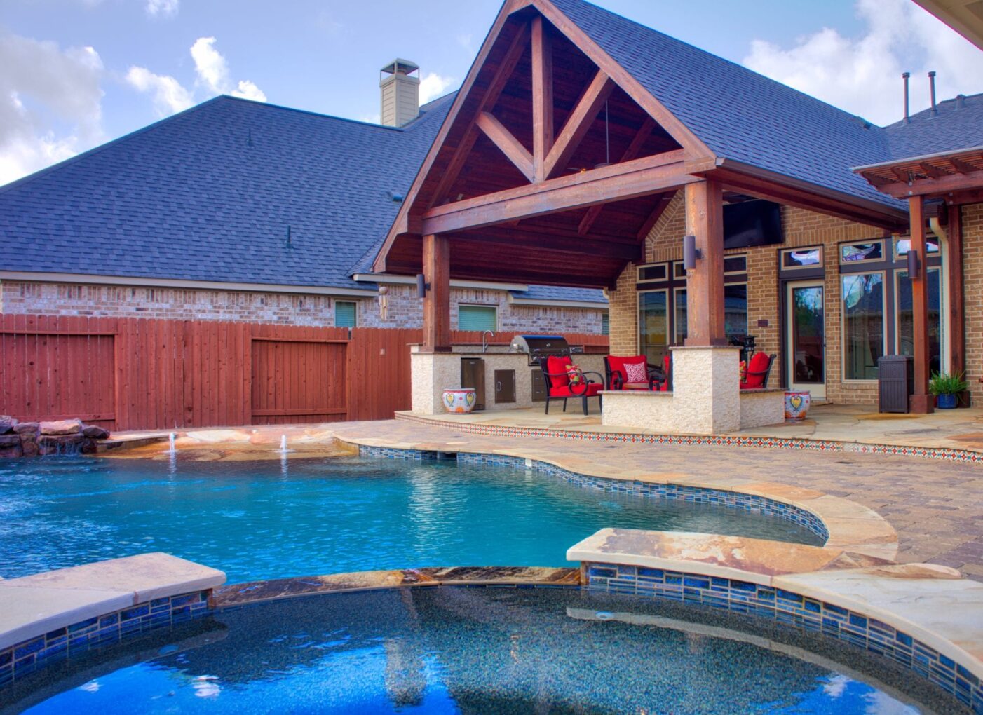 A pool with a large covered patio next to it.