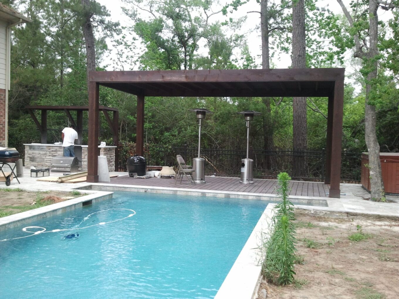 A pool with a wooden structure in the middle of it
