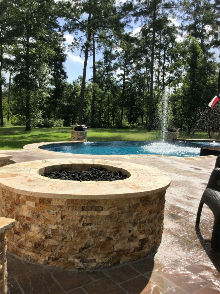 A fire pit in the middle of an outdoor pool.