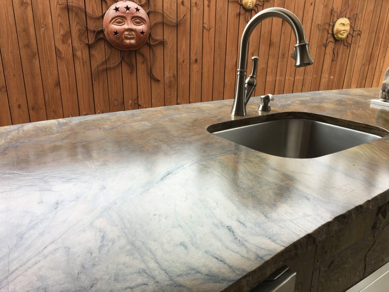 A sink and counter in the kitchen of a home.