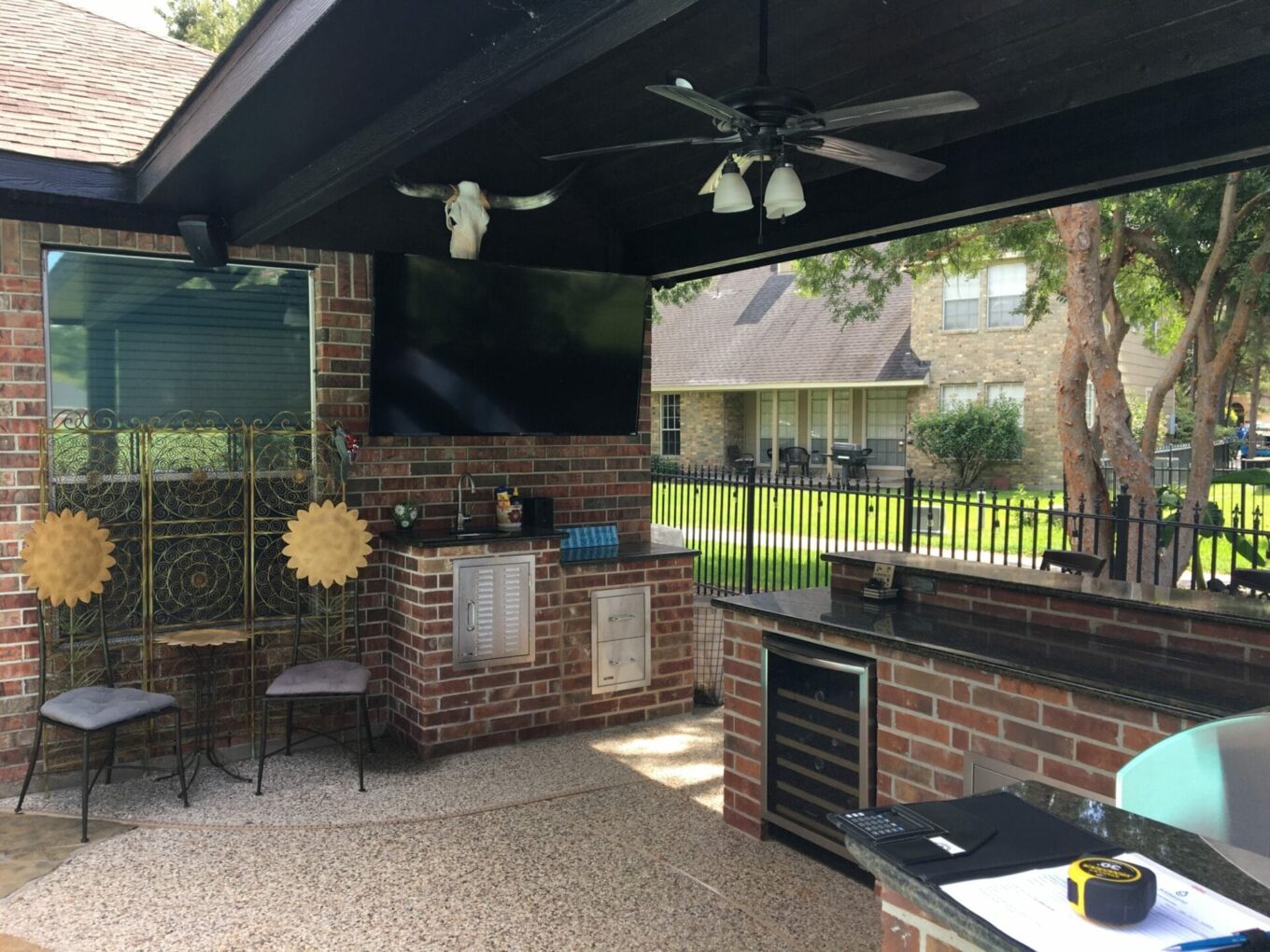 A patio with an outdoor tv and fireplace.
