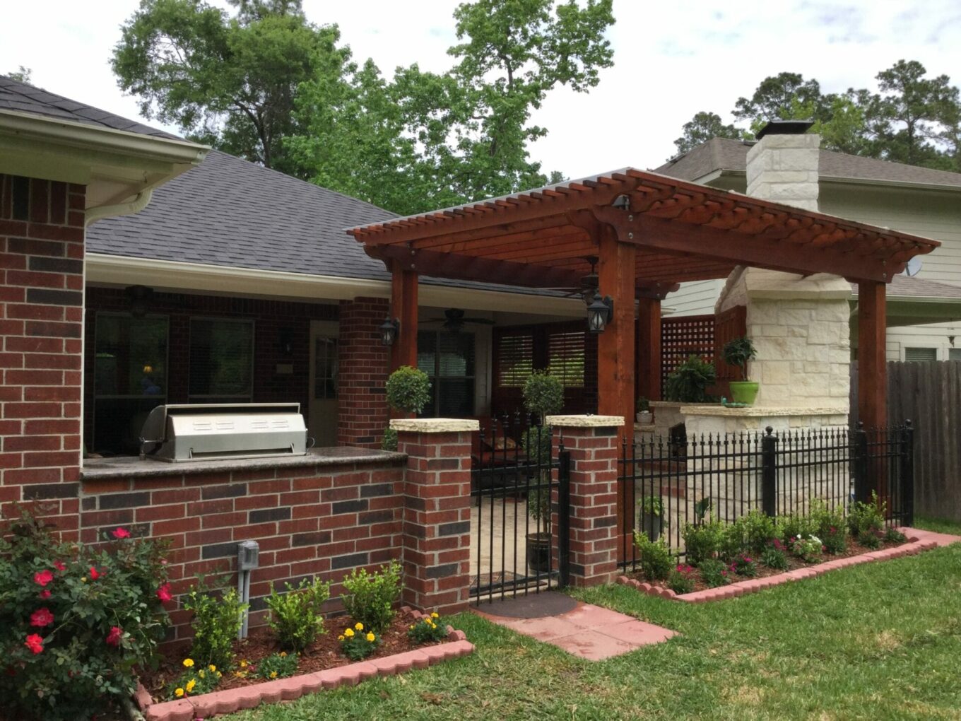 A brick house with a pergola and grill