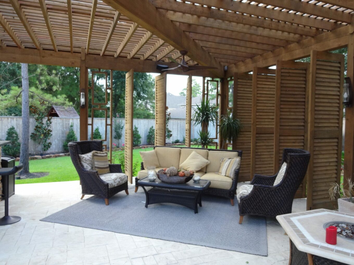 A patio with furniture and a pergola.