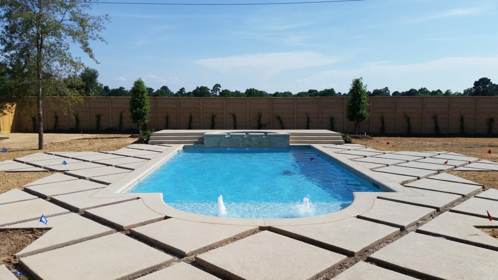 A swimming pool with a large concrete slab.