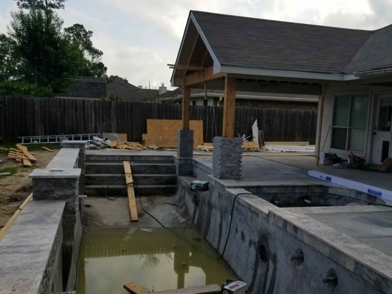 A pool that is being built in the yard.