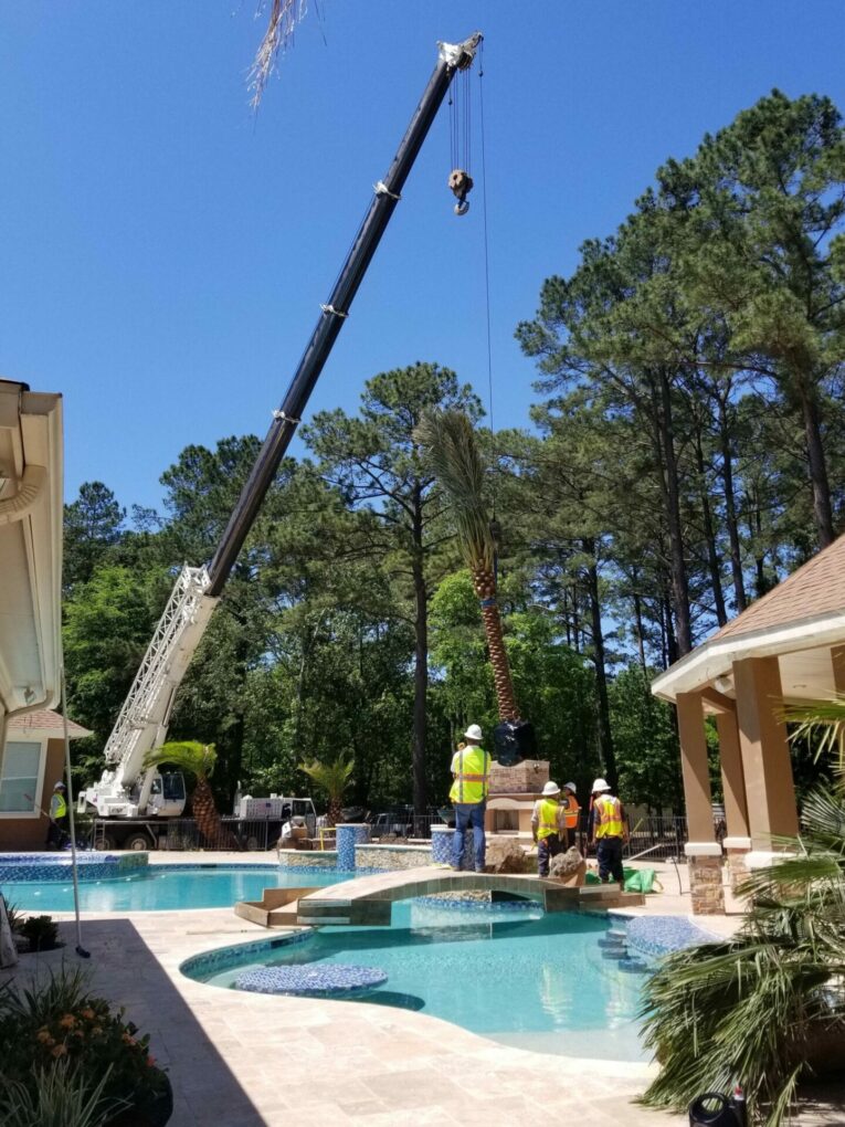 A crane is lifting up the roof of a pool.