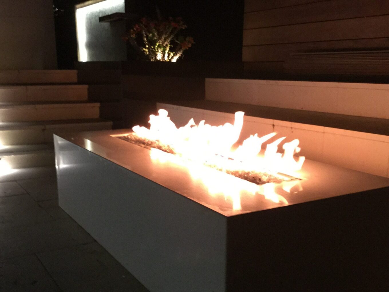 A fire pit with flames glowing in it.