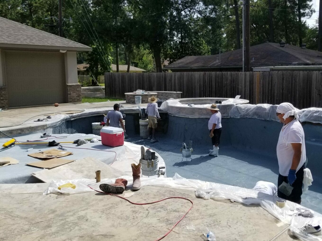 A group of people standing around a pool.